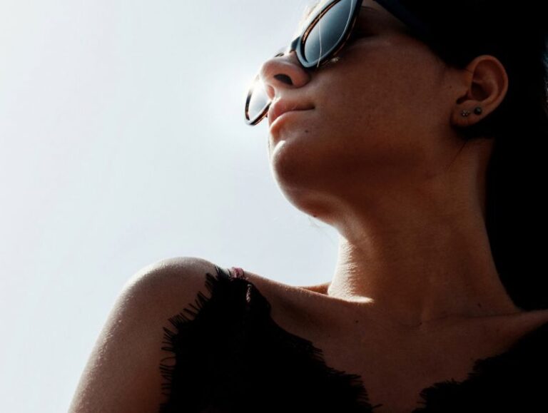 Traits - woman in black tank top wearing black sunglasses