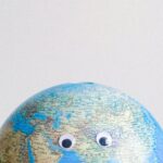 Impact - Sphere shaped miniature of Earth with googly eyes