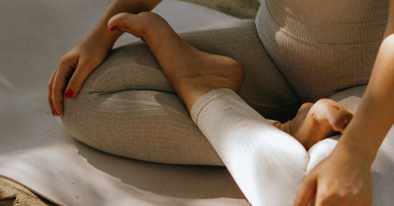 Practices - A Woman in Activewear Sitting on a Yoga Mat