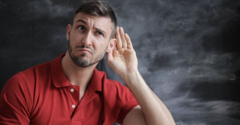 Listening - Man in Red Polo Shirt Sitting Near Chalkboard