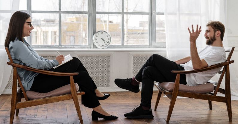 Practices - Person in Black Pants and Black Shoes Sitting on Brown Wooden Chair