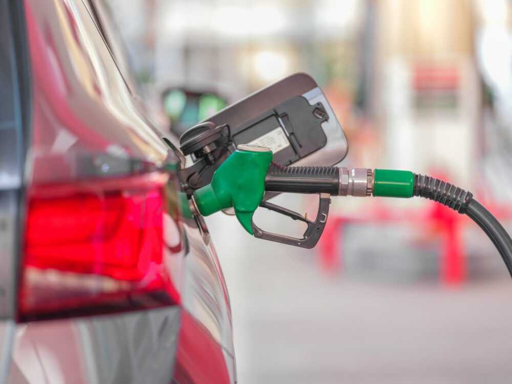 a-gas-pump-is-connected-to-a-car-at-a-gas-station